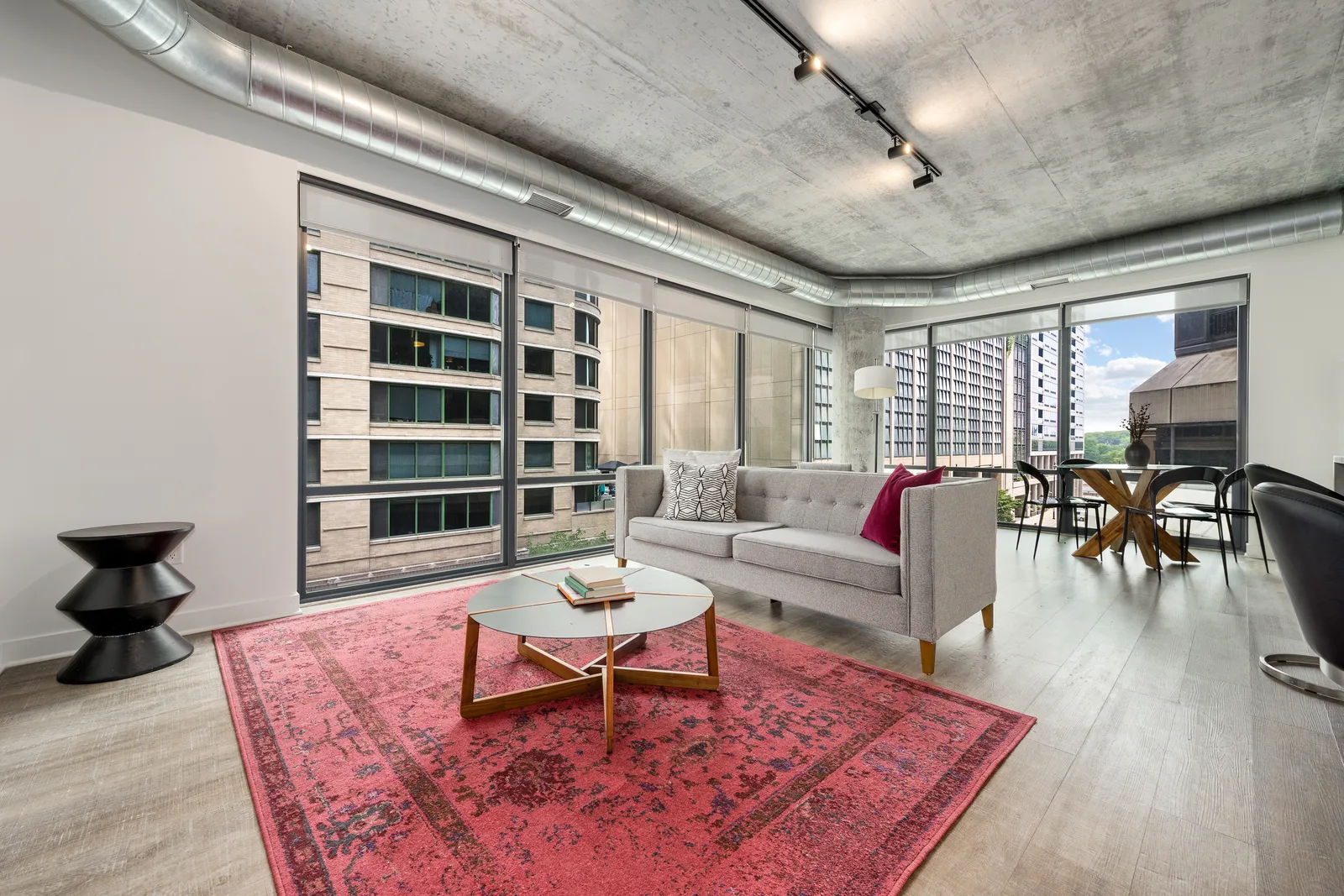 Corner living and dining room with floor-to-ceiling windows in a Sienna residence